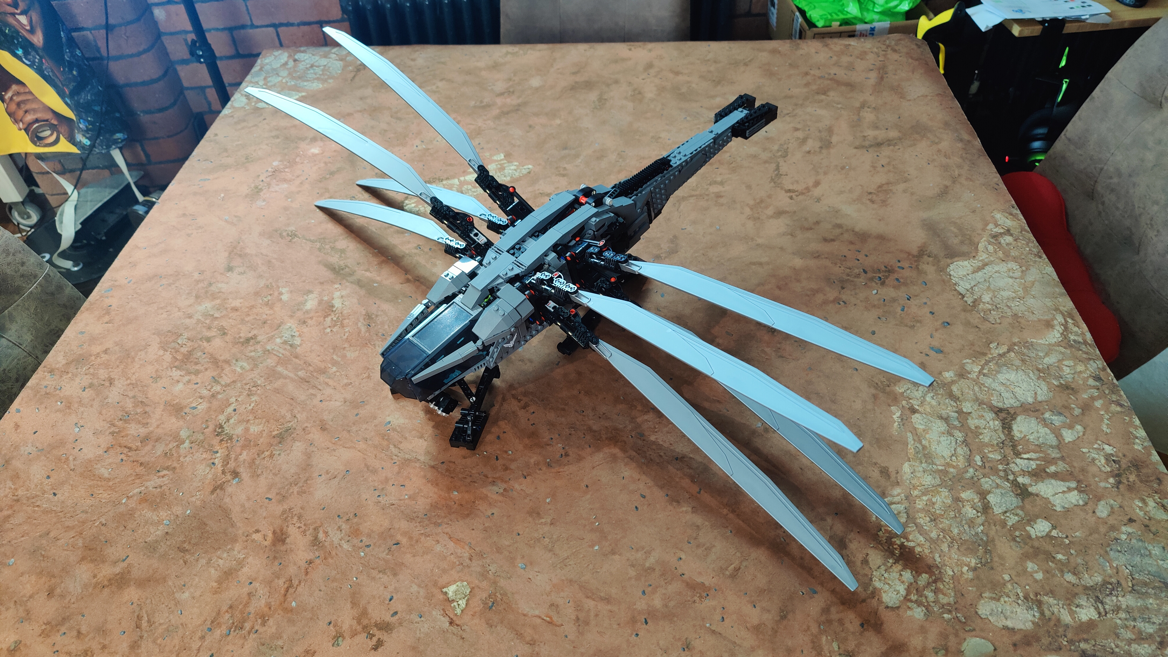 The Lego Dune Atreides Royal Ornithopter on a desert backdrop.