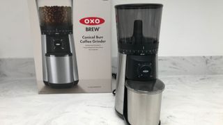 OXO grinder in front of the OXO box