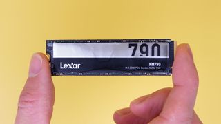 Lexar NM790 SSD on a yellow background with packaging.