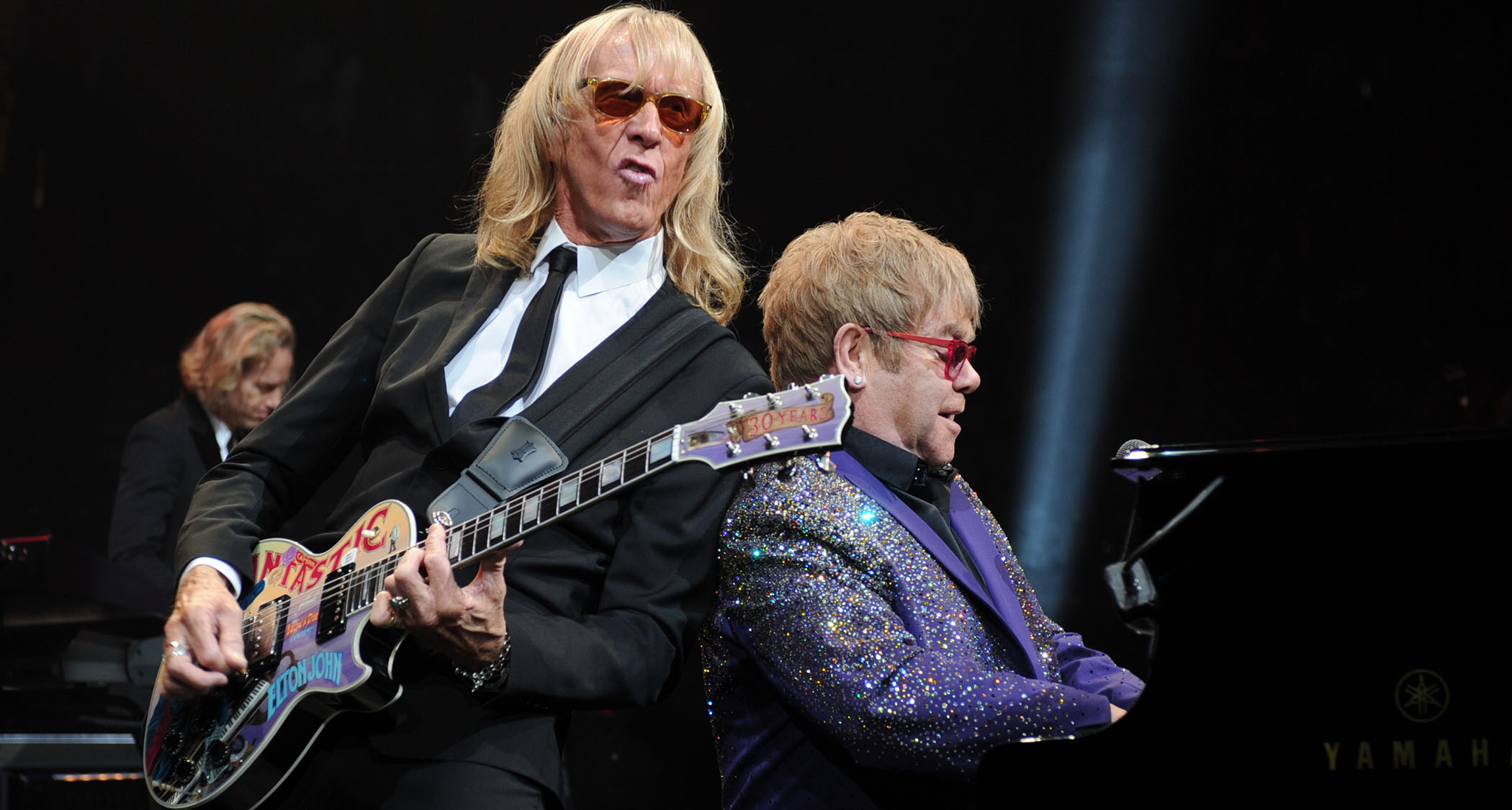 Davey Johnstone and Elton John are back-to-back as they perform live, with Johnstone playing his Captain Fantastic Les Paul Custom