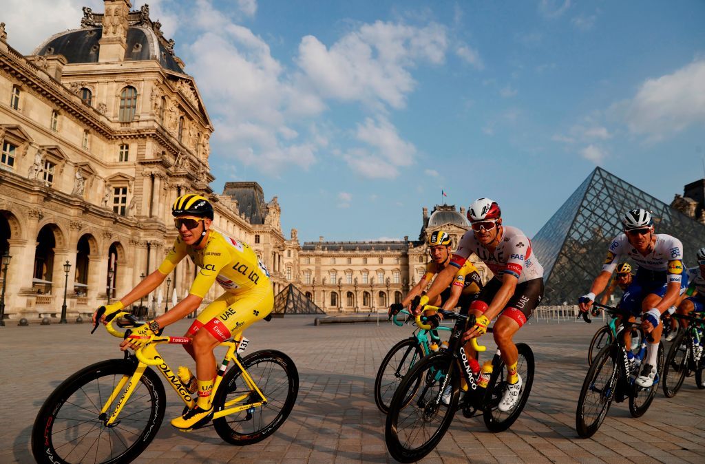 Team UAE Emirates rider Slovenias Tadej Pogacar 1stL wearing the overall leaders yellow jersey rides in the pack in front of the Louvre pyramid and museum during the 21st and last stage of the 107th edition of the Tour de France cycling race 122 km between ManteslaJolie and Champs Elysees Paris on September 20 2020 Photo by CHRISTIAN HARTMANN POOL AFP RESTRICTED TO EDITORIAL USE MANDATORY MENTION OF THE ARTIST UPON PUBLICATION TO ILLUSTRATE THE EVENT AS SPECIFIED IN THE CAPTION Photo by CHRISTIAN HARTMANNPOOLAFP via Getty Images