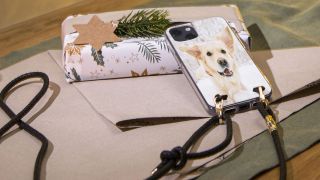 A phone case personalised with a dog photo comes with a detachable lanyard.