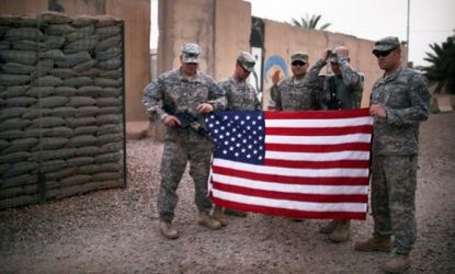 U.S. soldiers take pictures before their departure from Iraq in July: On Friday, President Obama announced that the rest of U.S. troops will be home by the end of 2011.