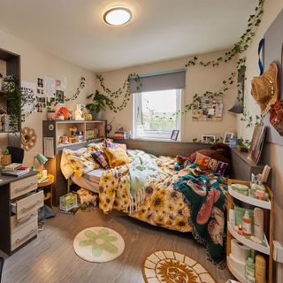 Decorated university bedroom with patterned bedding, artificial vines, and assorted home decor