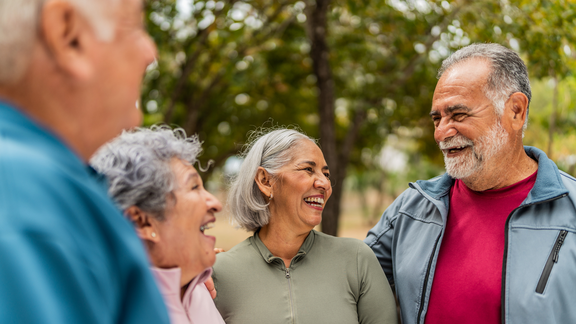 A group of gray-haired people all stand together