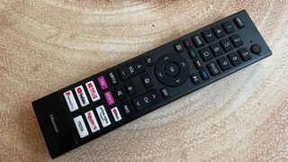 Hisense A7G review - a TV remote on a wooden surface