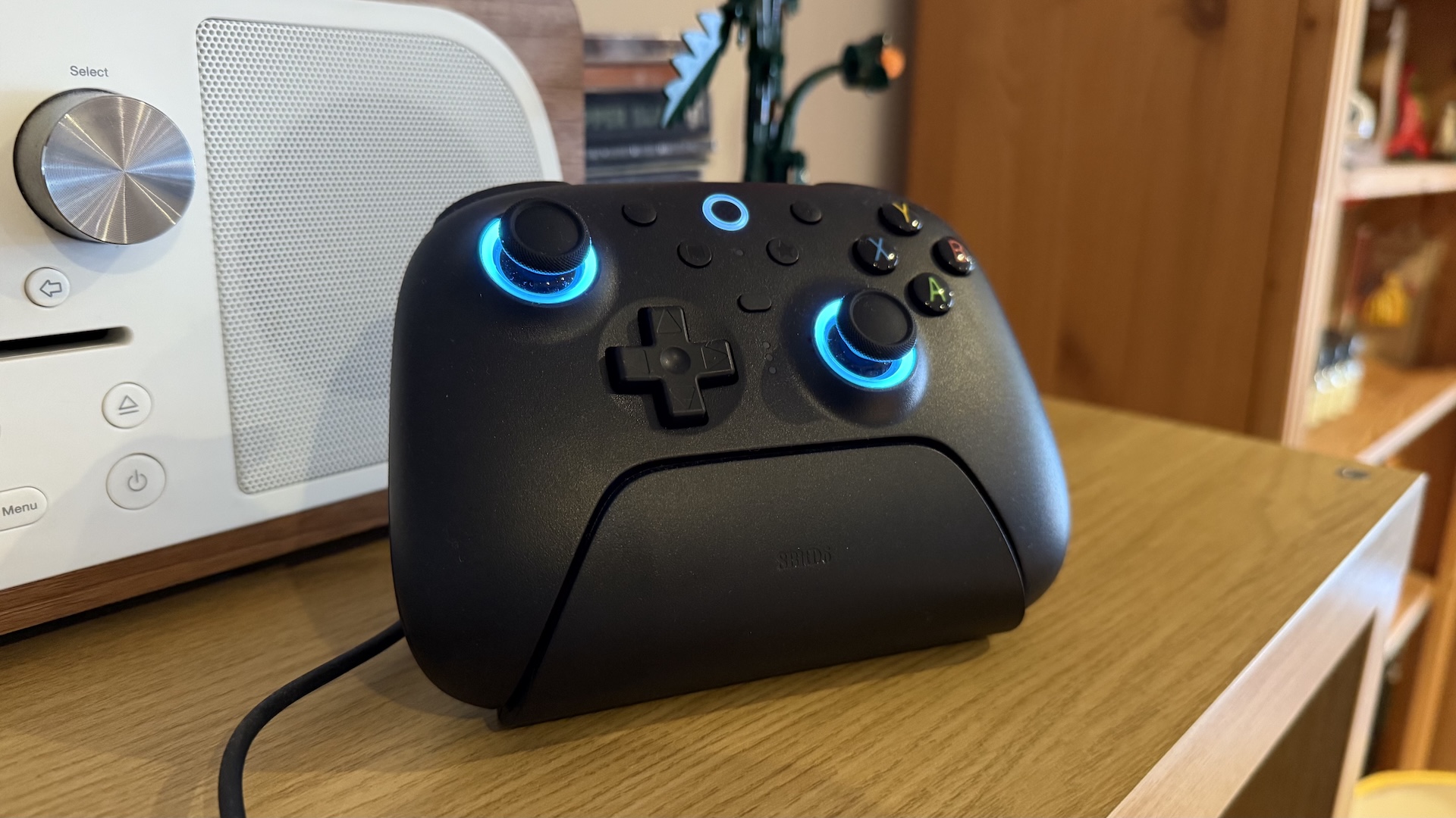 The 8BitDo Ultimate 2 controller, with dock and USB connection at home