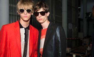 Male models wearing jackets and sunglasses