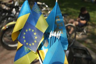A Ukrainian flag mixed with the flag of the European Union stands among flags for sale at a vendor's stall on September 14, 2014 in Lviv, Ukraine. The European Union announced today that it will delay implemenation of the EU association agreement, which would promote free trade between the EU and Ukraine, until the end of 2015 in a move meant to address concerns by Russia.