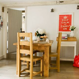 dining room with white walls and wooden table with chairs