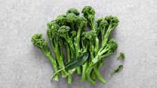 Cut broccolini stems and florets on a white surface