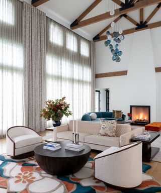 White living room with dark wooden beams