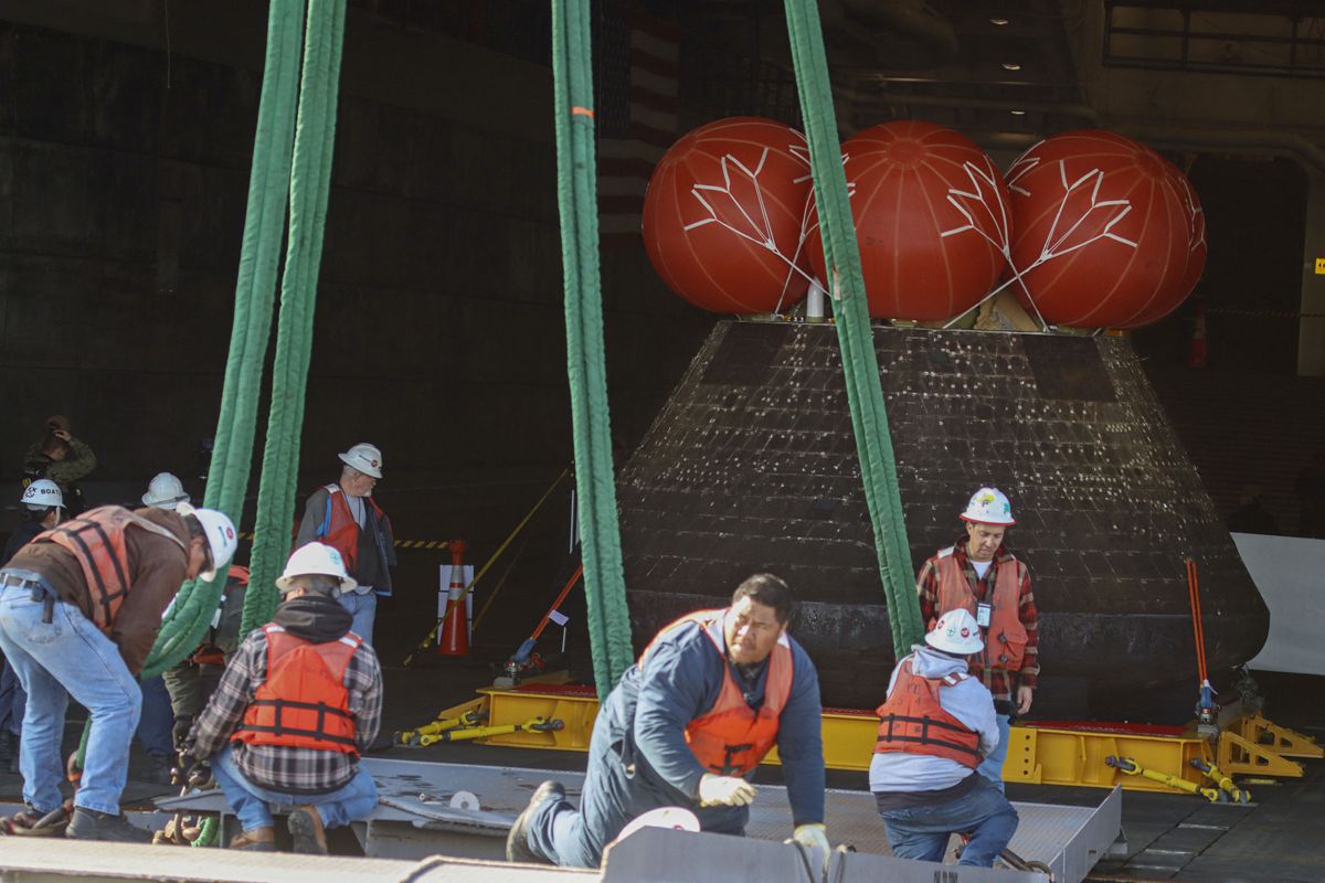 Pictures of the Orion spacecraft being treated after arriving in port in San Diego on Dec. 13, 2022.