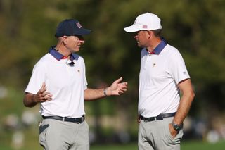 Jim Furyk and Keegan Bradley chat during day 2 of the Presidents Cup