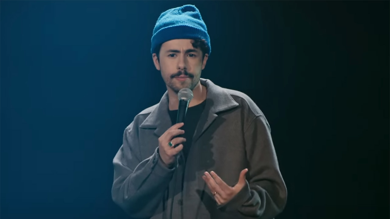 Ramy Youssef tells a joke onstage in his comedy followup More Feelings.