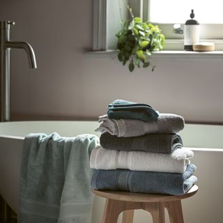 folded towels on stall in bathroom