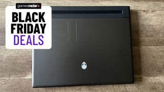 Alienware M16 gaming laptop on a wooden table with a purple Black Friday deals badge