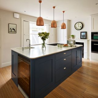 kitchen with white wall and navy blue cabinet with marble worktop