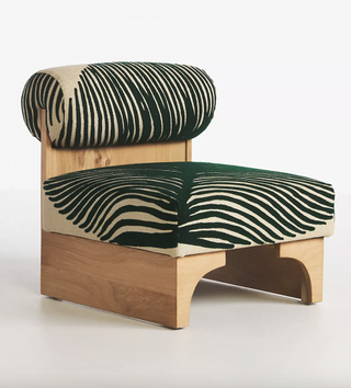 Green and white leaf motif chair made of natural wood from Anthropologie.