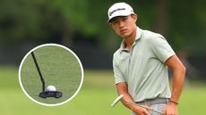 Collin Morikawa watches a putt and his putter in a circle