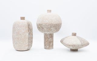 A trio of natural-tone, stone-effect vases