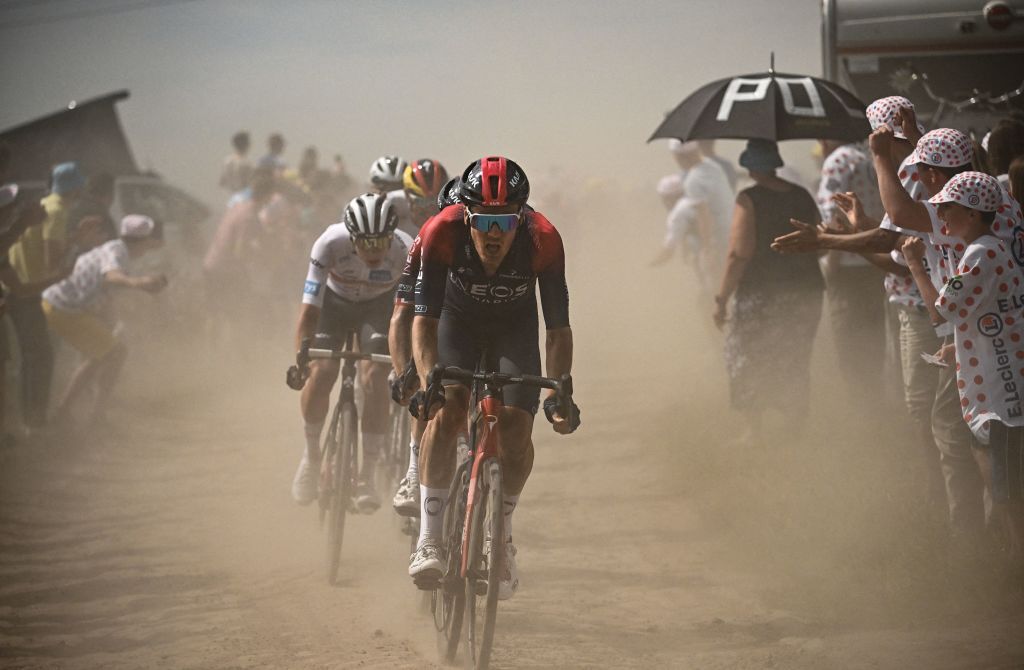 The pack of riders kicks up dust as it cycles across a cobblestone sector during the 5th stage of the 109th edition of the Tour de France cycling race 1537 km between Lille and Arenberg Porte du Hainaut in northern France on July 6 2022 Photo by Marco BERTORELLO AFP Photo by MARCO BERTORELLOAFP via Getty Images