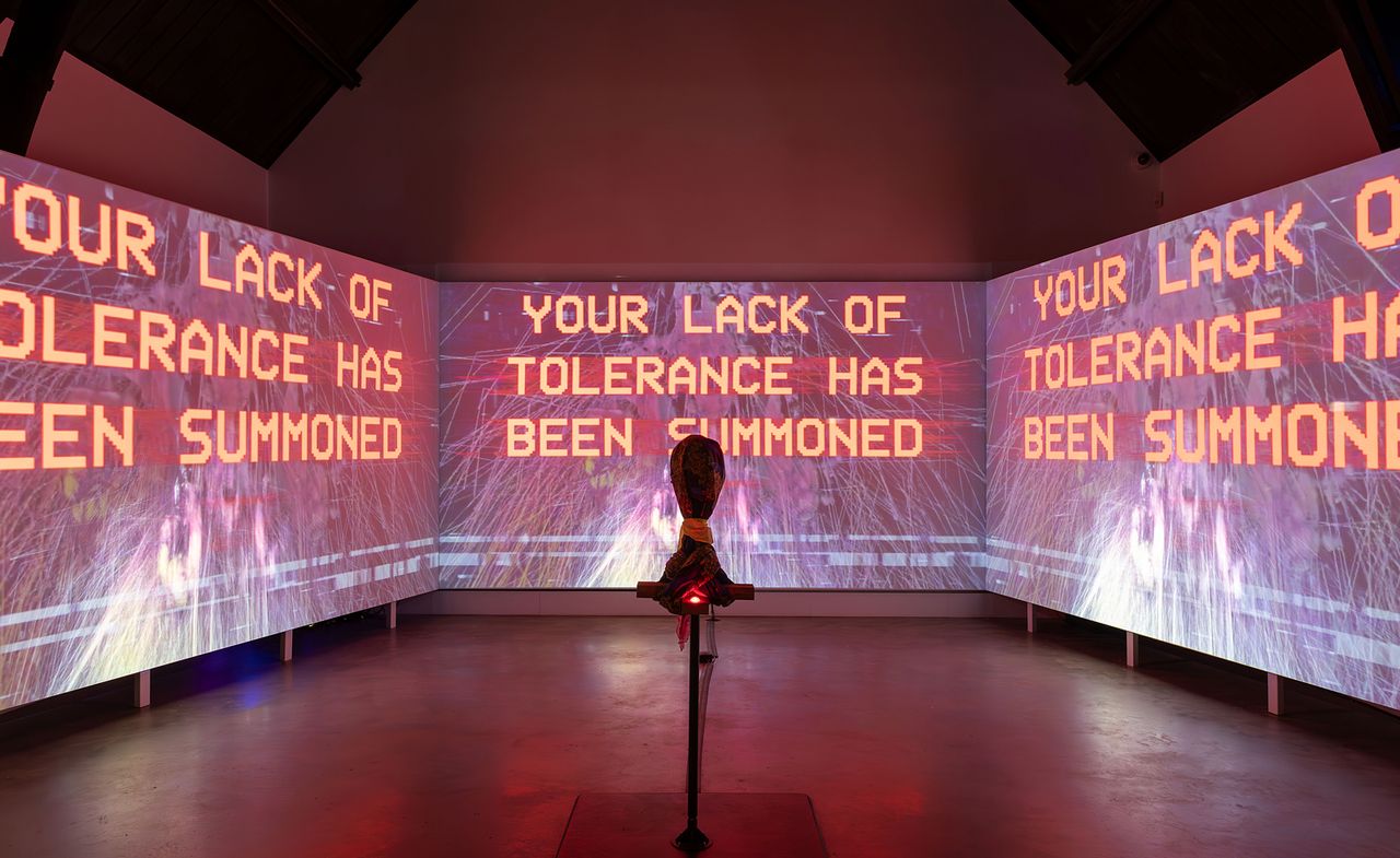 big screens with red letters on: Danielle Brathwaite-Shirley The Rebirthing Room exhibition at Studio Voltaire