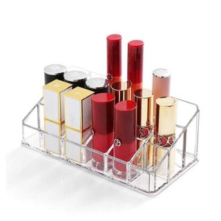 An acrylic lipstick holder filled with lipsticks