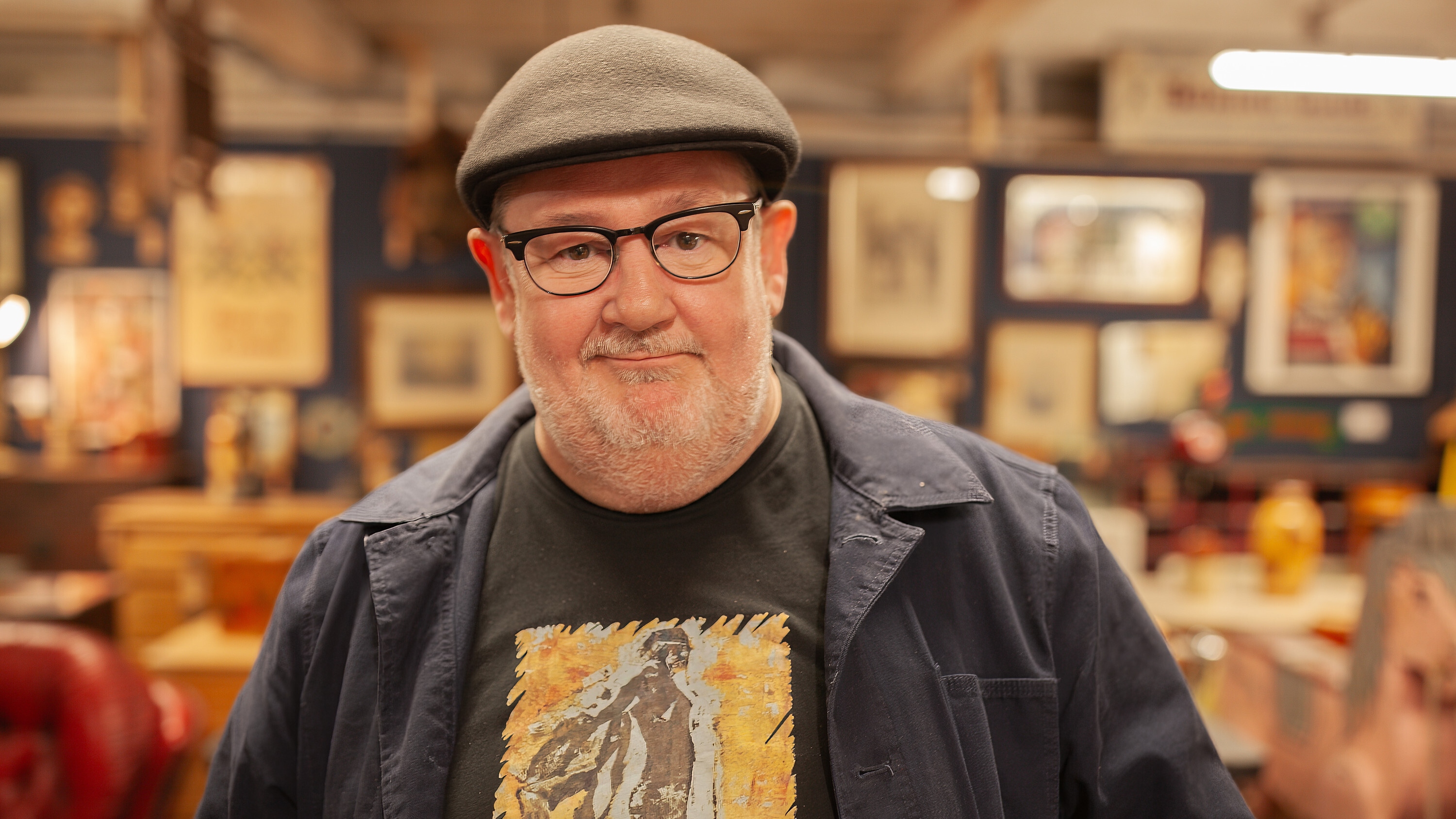 Johnny Vegas standing in a picture shop smiling to the camera