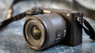 A photo of the Sony E 11m f/1.8 lens mounted on a camera