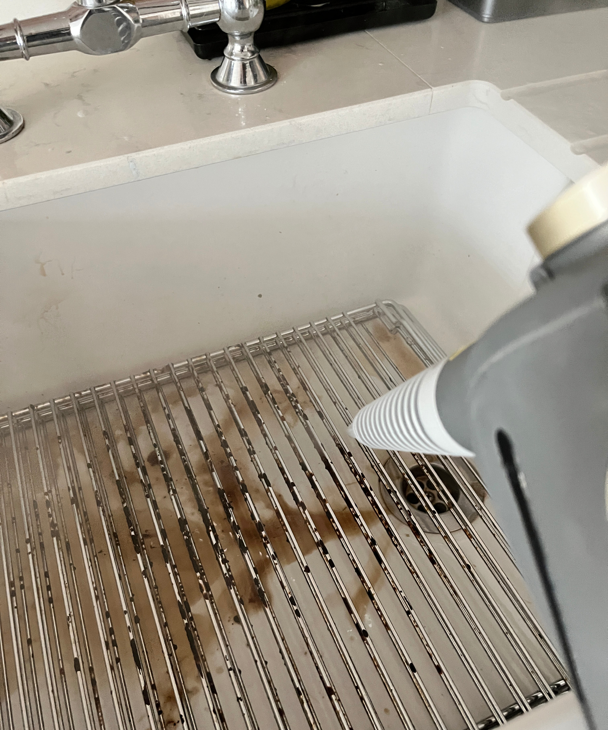 steam cleaner being used to clean wire oven rack sin white belfast undercounter sink