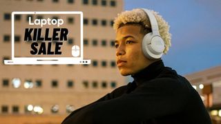 Man outside wearing beige JBL Tune 720BT wireless headphones