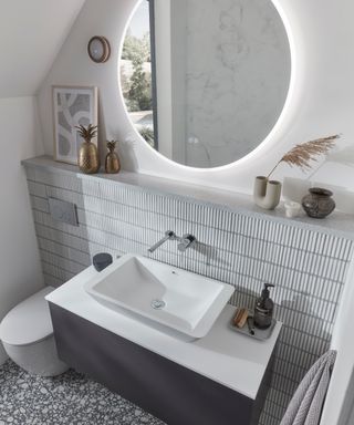 A bathroom with vanity, shelving, and mirror