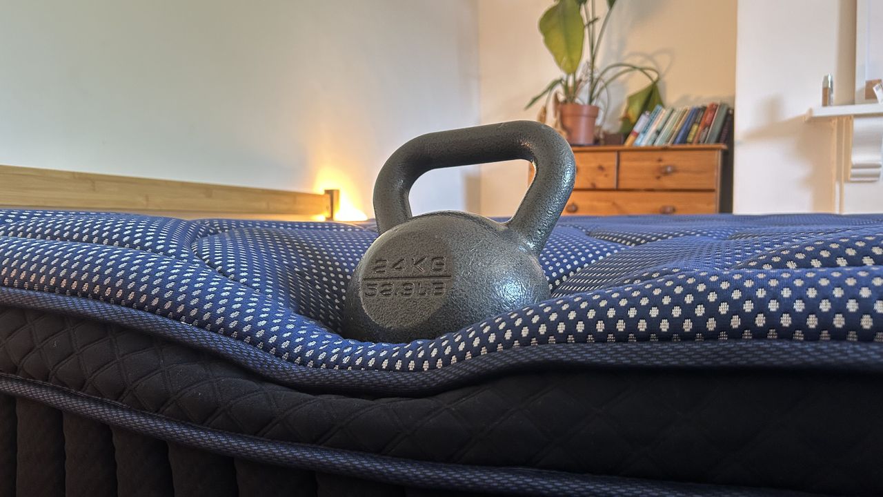 A weight resting on the edge of the DreamCloud Luxe Memory Foam mattress to measure edge support