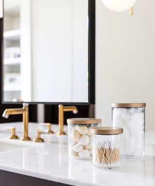Storage canisters on bathroom countertop