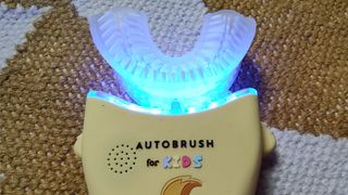 The rear of the AutoBrush Sonic Pro for Kids with the blue light turned on.