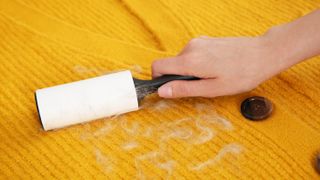 Rolling lint off yellow sweater