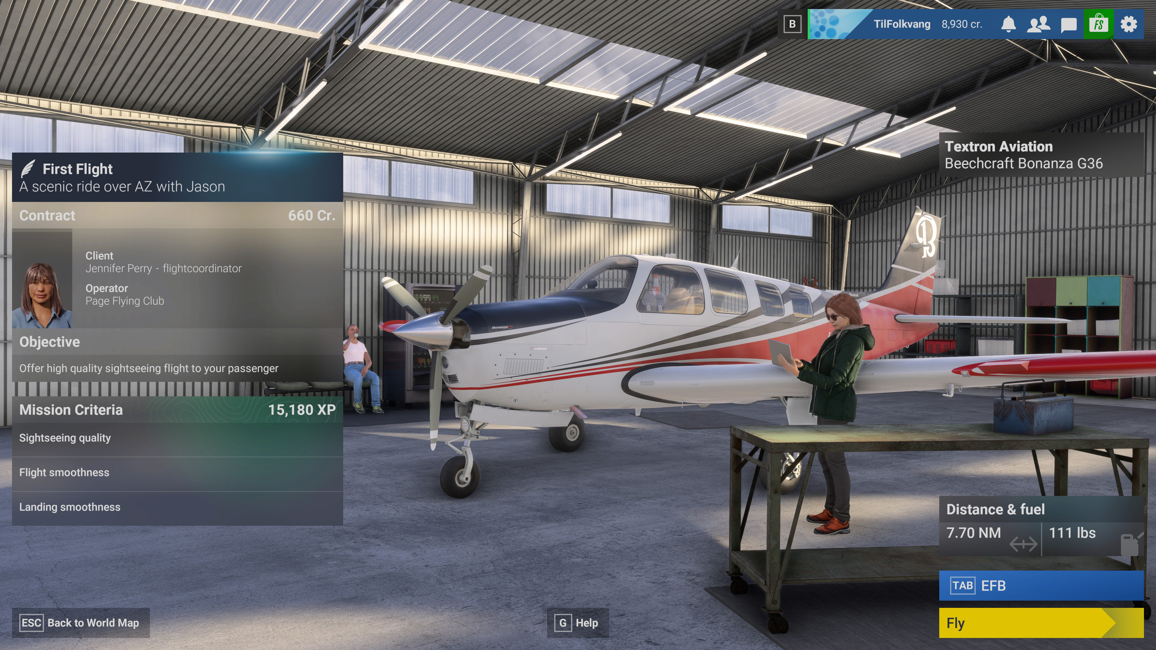 An small airplane in a hangar with a pilot standing nearby