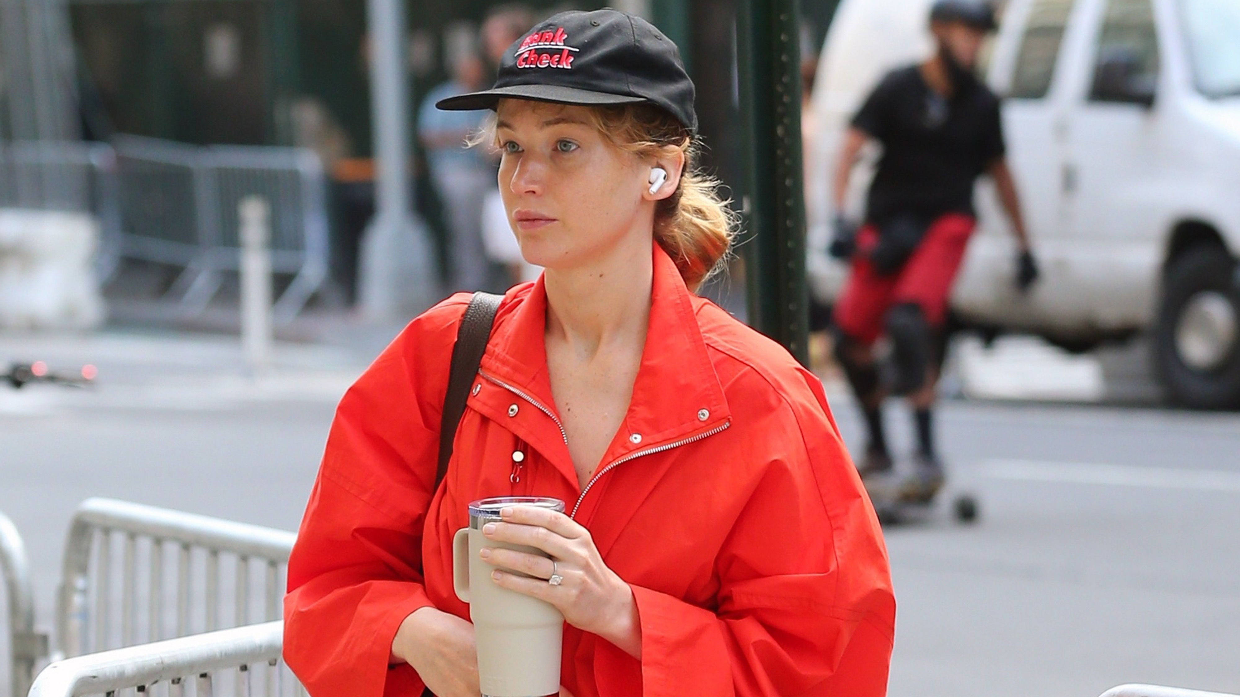 Jennifer Lawrence stepped out of a workout in New York City, wearing a bright red Roucha Janssen jacket paired with Alo tights and casual Adidas slides.