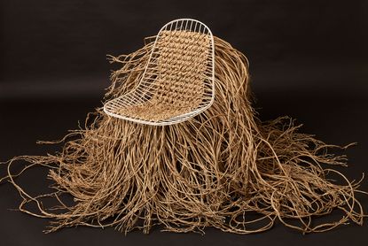 Wire chair with lots of brown straw decoration