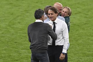 Roberto Mancini, right, greets Spain manager Luis Enrique after the game