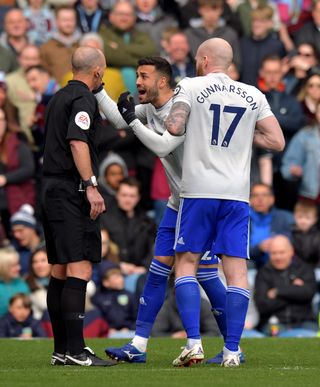 Cardiff’s Victor Camarasa confronts Mike Dean after the referee overturned a penalty decision