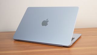 Apple MacBook Air 13-inch M4 angled away from the camera showing the lid with Apple logo.