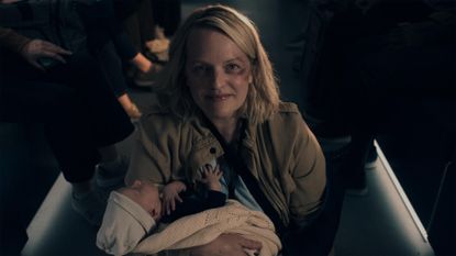 June smiles as she holds a baby in The Handmaid's Tale season 6