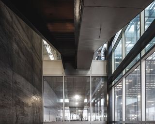 Interior of the Blox Building. Concrete and glass walls with a high roof.