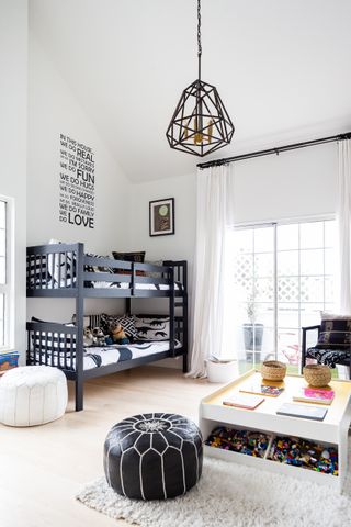 A kids black and white schemed bedroom with black bunk beds