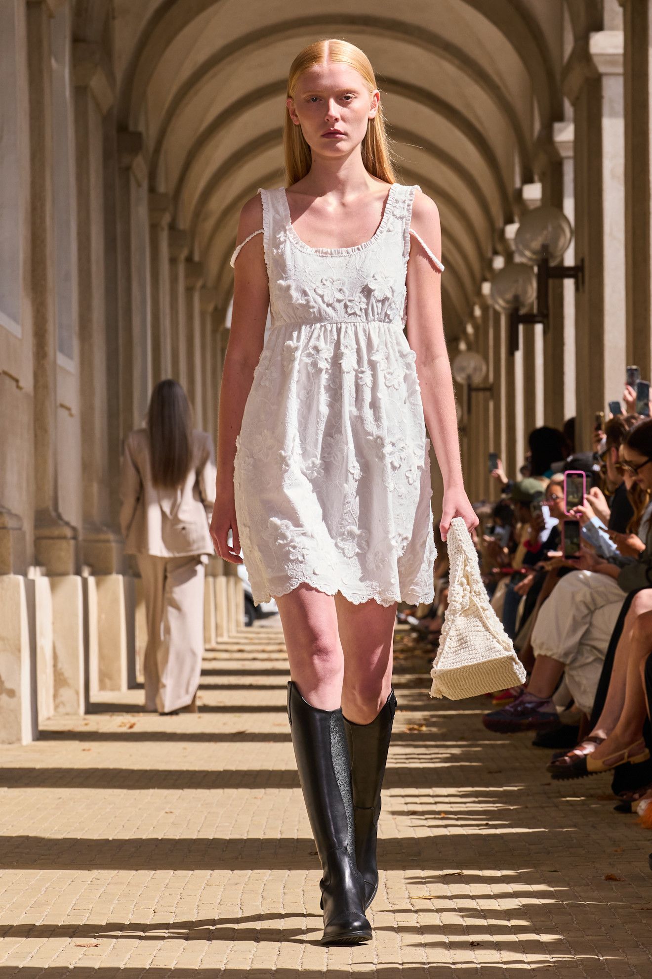 The Garment model wearing riding boots.