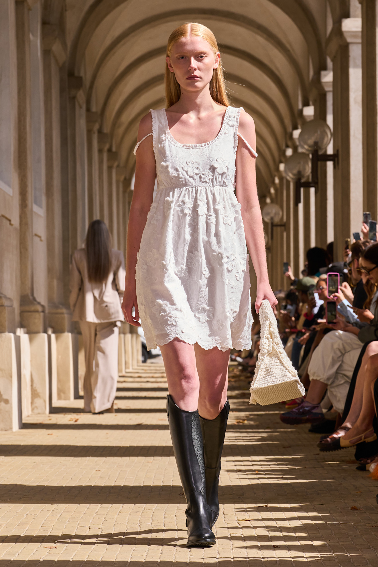 The Garment model wearing riding boots.