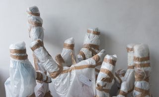 Various objects wrapped in bubble wrap and packaging tape.