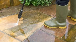 washing patio with pressure washer